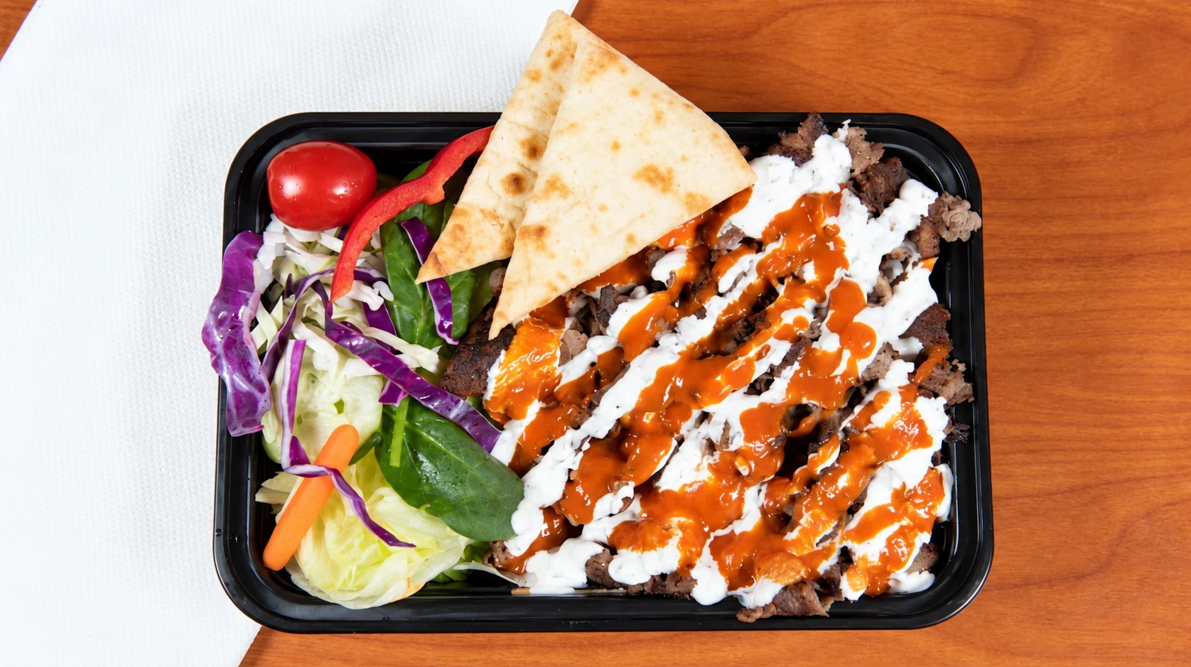 Lamb over rice and salad at Box’d Kitchen